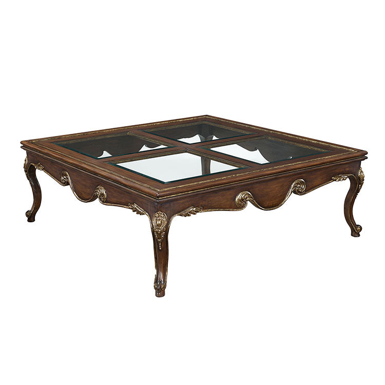 a wooden coctail table with a glass top on a white background