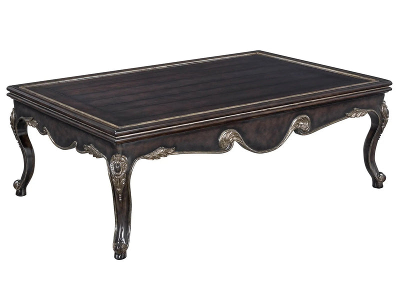 a wooden coctail table with carvings on it