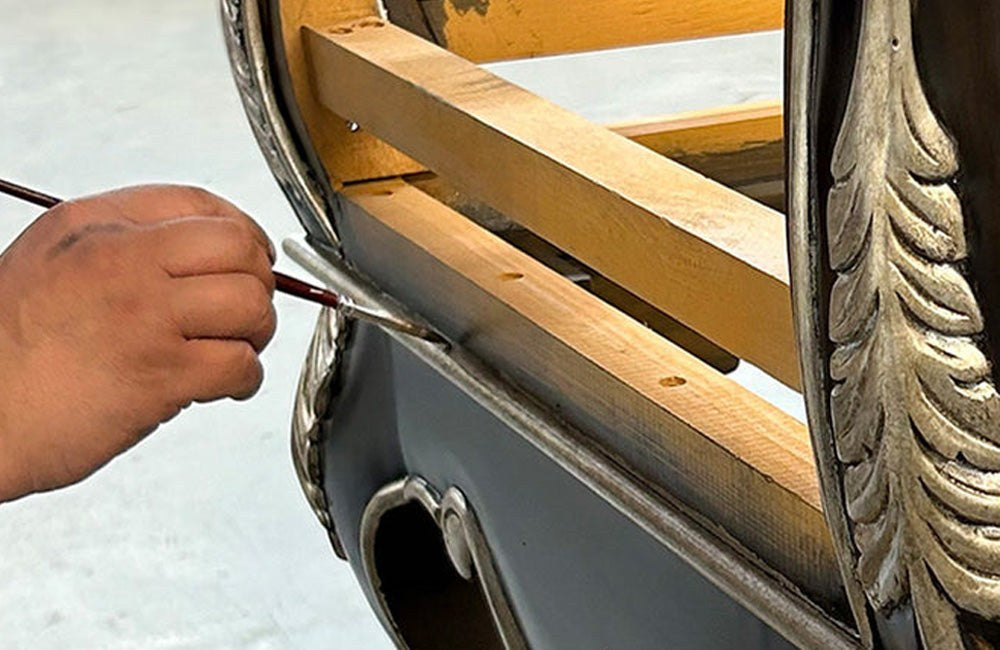 Brushing a finish onto carved detail