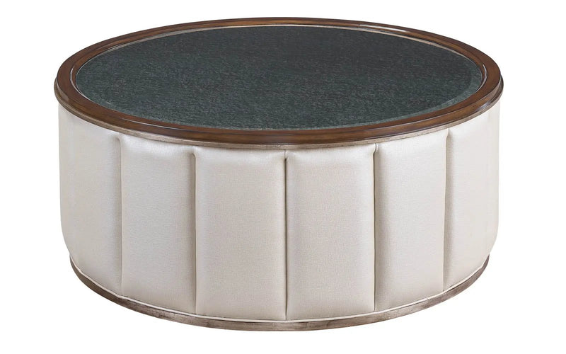 a white and brown round table with a black top